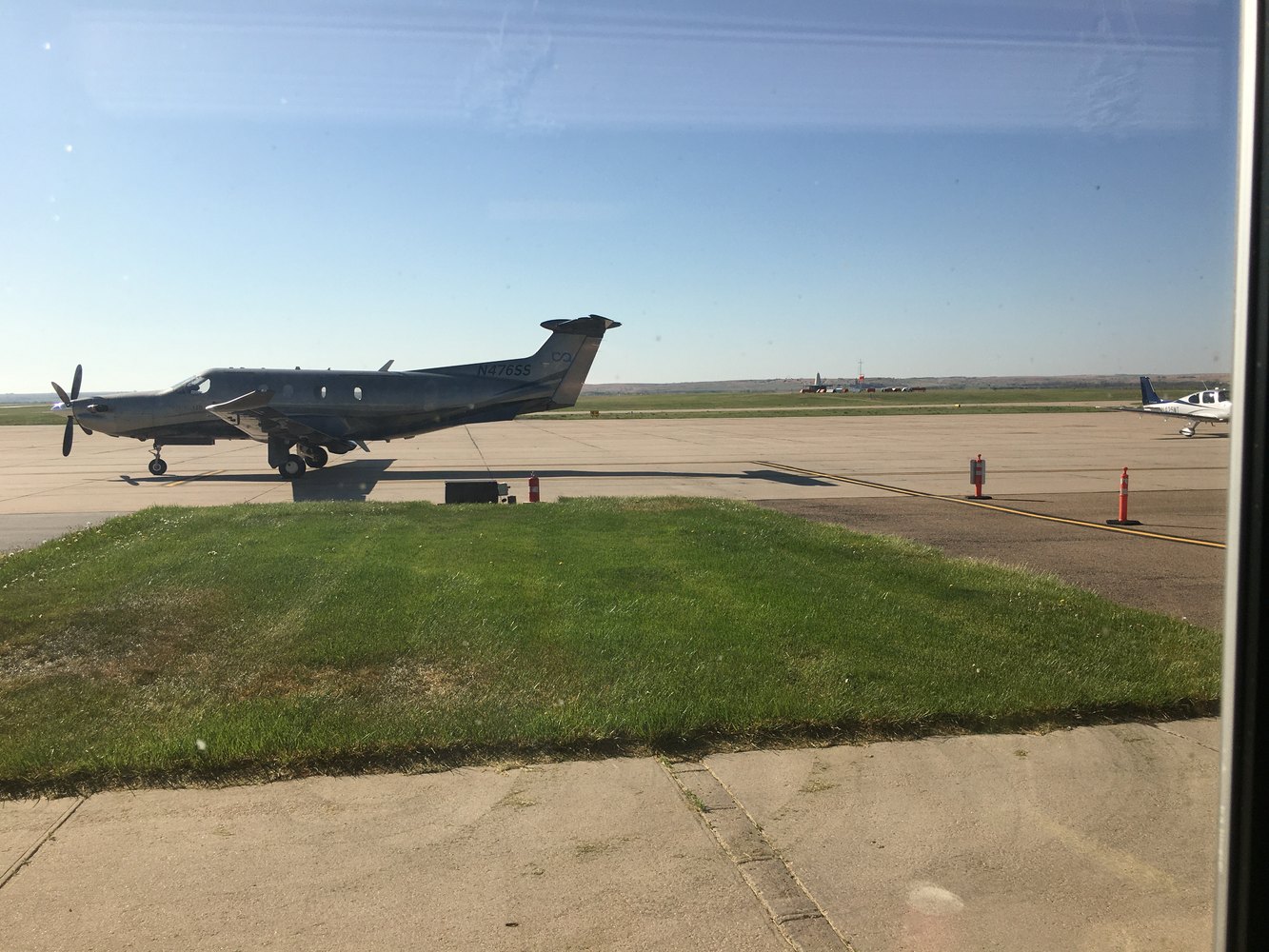 Pilatus PC-12 parked on the ramp under clear skies